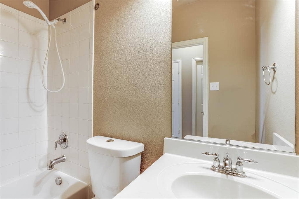 1014 Kaylie Street, Grand Prairie, TX 75052 White vanity with an integrated sink and chrome faucet
