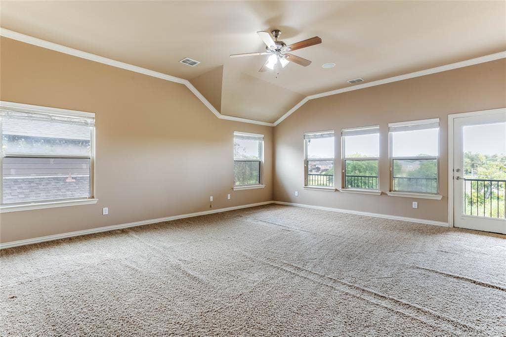 1014 Kaylie Street, Grand Prairie, TX 75052 Vaulted ceiling with crown molding, ceiling fan, and multiple windows