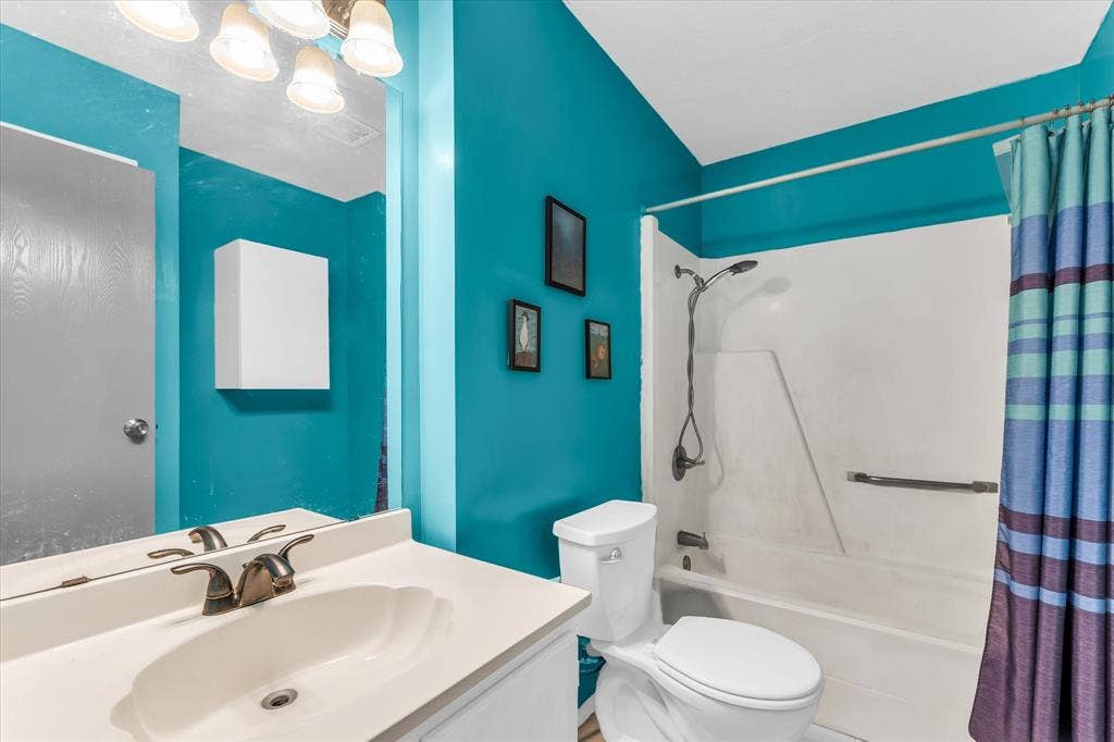 261 Oakview Circle, Waco, TX 76705 White vanity with integrated sink, bronze-finish faucet, and overhead lighting