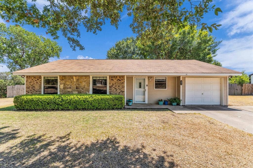 261 Oakview Circle, Waco, TX 76705 Single-story residence featuring a brick and stone facade, attached garage, and well-maintained front landscaping
