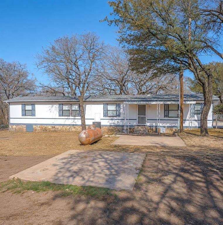 6048 Hidden Circle, Azle, TX 76020 Single-story residence featuring white siding and dark blue shutters