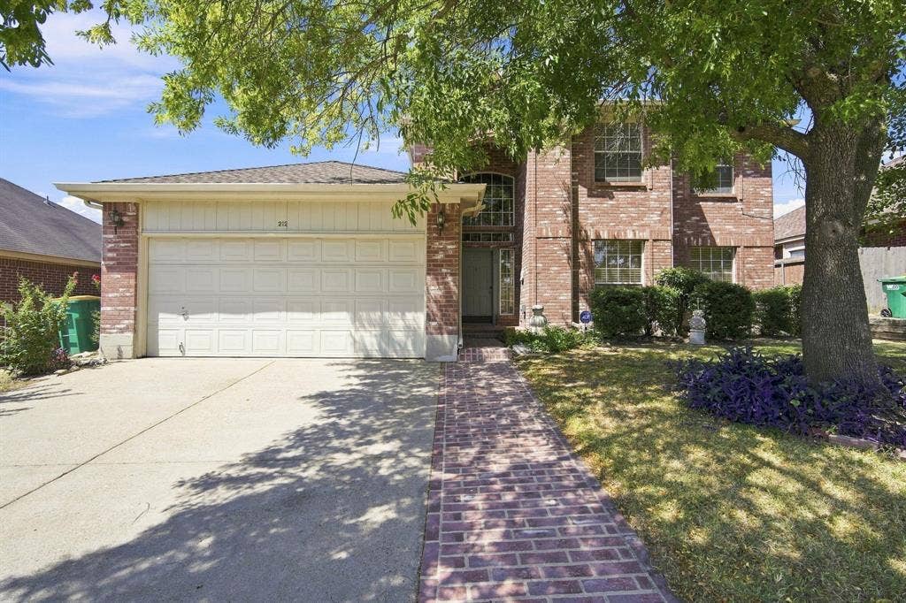 Brick exterior with a prominent two-car garage