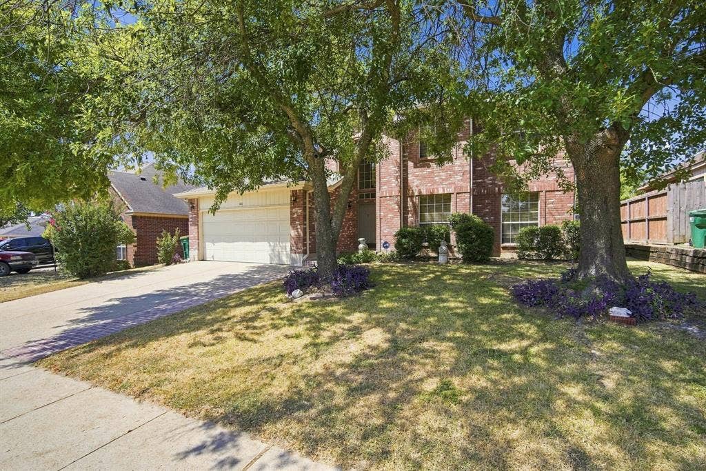 Brick exterior with a two-car garage and a concrete driveway