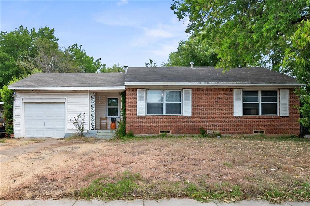1405 Grace Street, Arlington, TX 76010 Brick and siding exterior with an attached single-car garage, front porch, and front yard