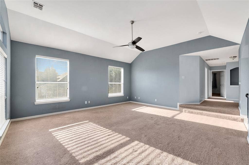 2106 Hillside Drive, Rowlett, TX 75088 Spacious game room with vaulted ceilings, ceiling fan, and plush carpet.
