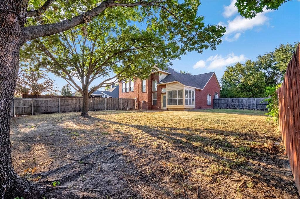2106 Hillside Drive, Rowlett, TX 75088 Expansive, fully fenced backyard featuring mature shade trees and plenty of space for outdoor entertaining, play, or creating your own private retreat.