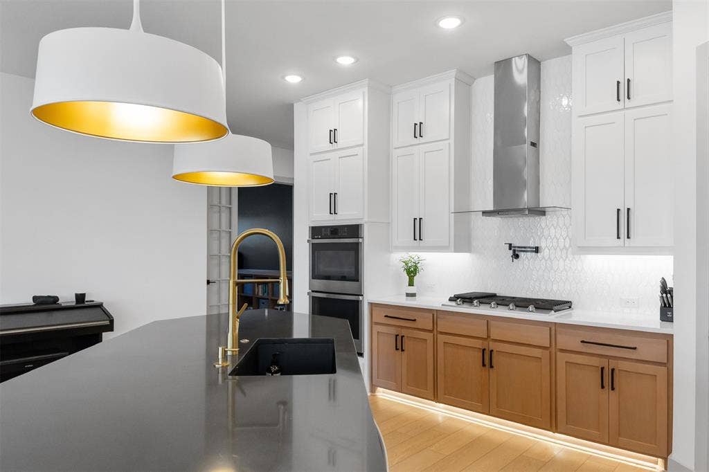 2308 Clancy Drive, Northlake, TX 76247 Kitchen featuring a dark countertop island, white and natural wood-tone cabinetry, stainless steel range hood, and pendant lighting