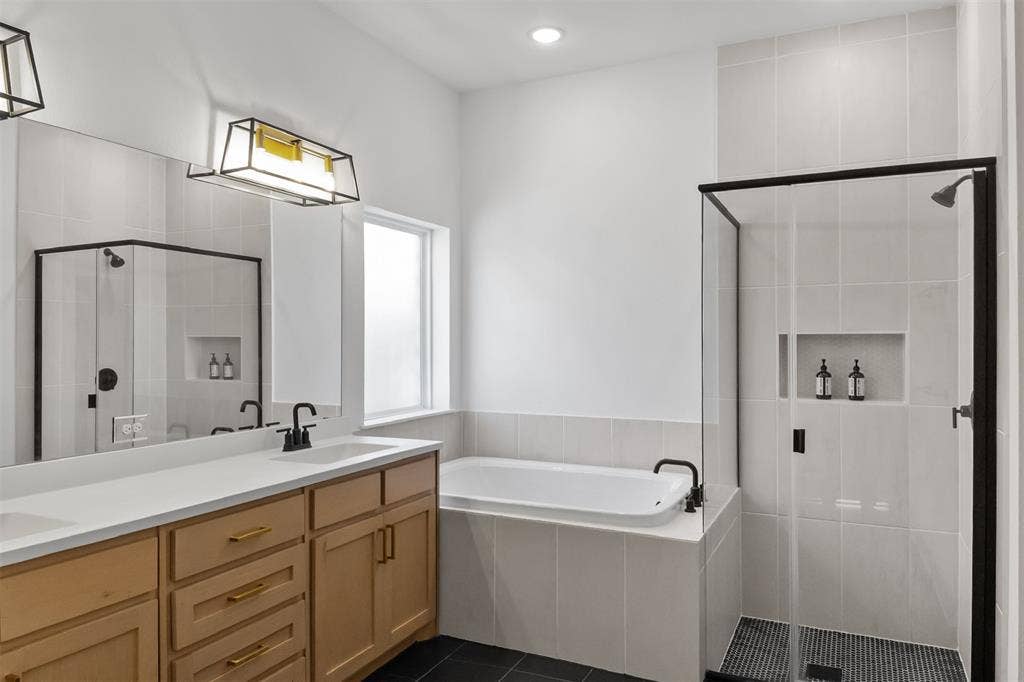 2308 Clancy Drive, Northlake, TX 76247 Dual vanity with wood-finish cabinetry, white countertop, and matte black fixtures