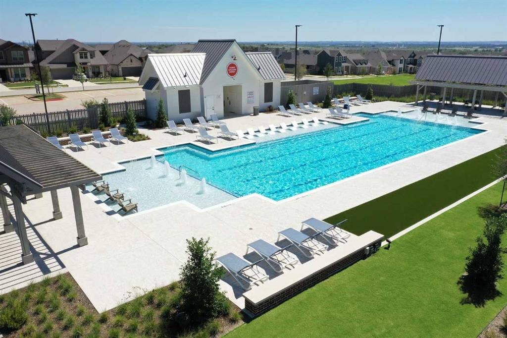 2308 Clancy Drive, Northlake, TX 76247 Outdoor swimming pool with integrated fountains, adjacent clubhouse, and shaded pergola
