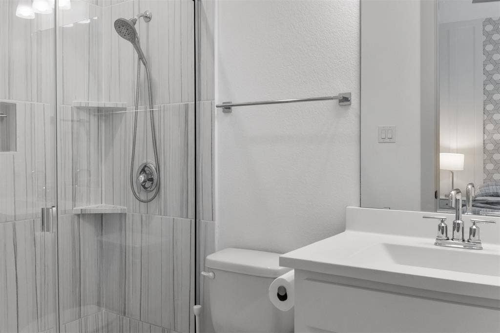 2308 Clancy Drive, Northlake, TX 76247 2nd-primary-bed-room's ensuit bath with glass-enclosed shower with tiled walls and built-in shelving