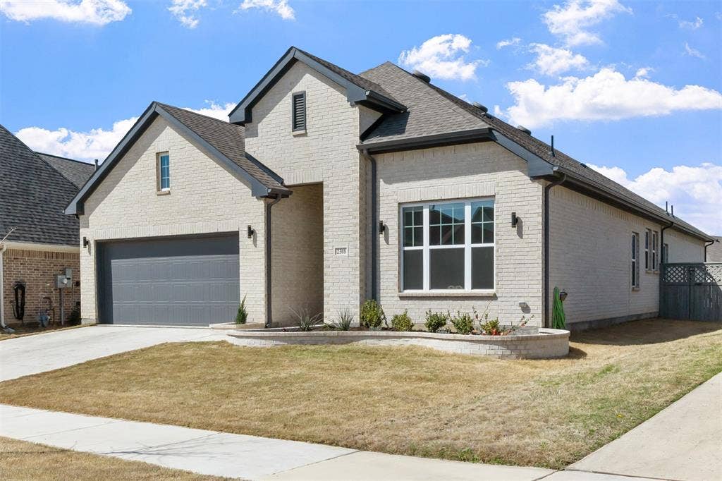 2308 Clancy Drive, Northlake, TX 76247 Light brick exterior with dark trim and a dark gray garage door