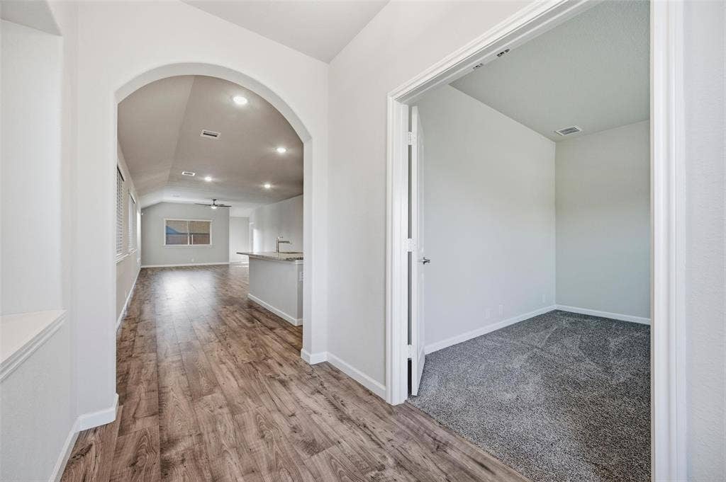 4425 Ridgehurst Lane, Fort Worth, TX 76036 Bright entryway showcasing wood-finish flooring, arched architectural detailing, recessed lighting, and seamless access to multiple rooms