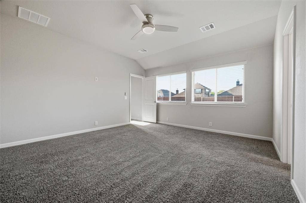4425 Ridgehurst Lane, Fort Worth, TX 76036 Carpeted room featuring multiple windows with blinds, a ceiling fan with integrated lighting, and painted walls