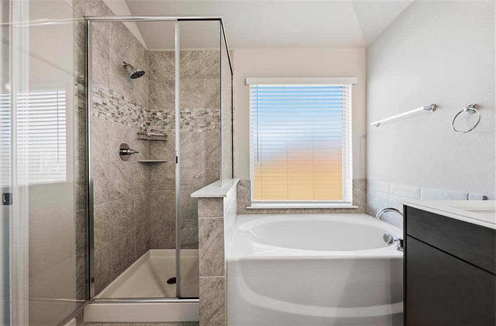 4425 Ridgehurst Lane, Fort Worth, TX 76036 Walk-in shower with full tile surround, integrated shelving, and glass enclosure