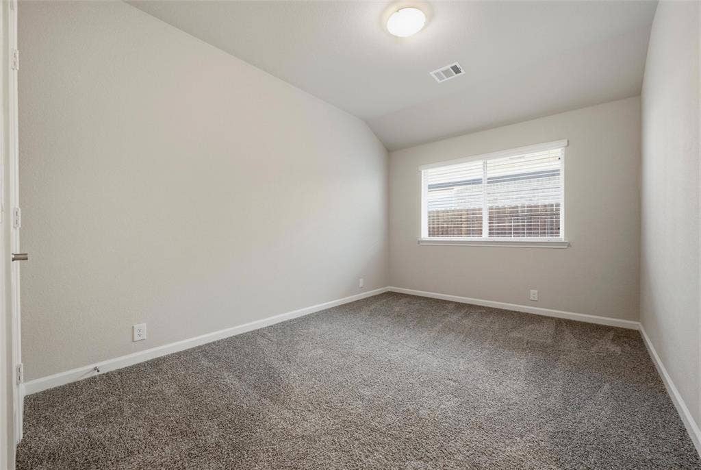 4425 Ridgehurst Lane, Fort Worth, TX 76036 Neutral-toned walls, textured gray carpeting, white trim, recessed lighting, and a window with blinds