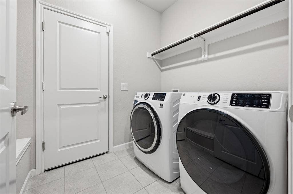 4425 Ridgehurst Lane, Fort Worth, TX 76036 Laundry area featuring tile flooring, white walls, and an overhead clothes rod