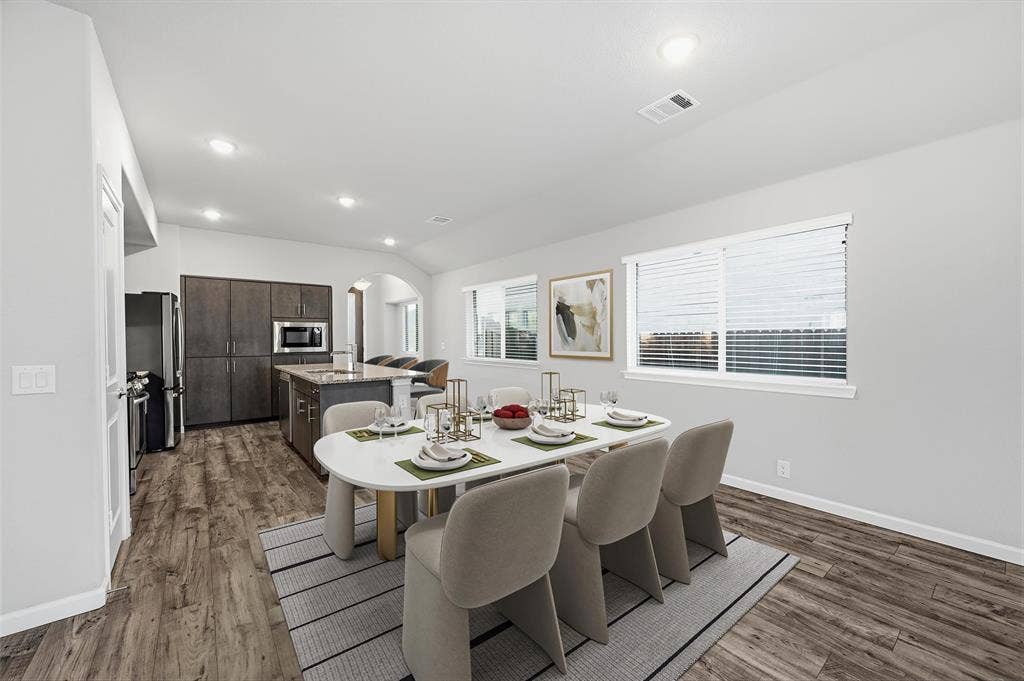 4425 Ridgehurst Lane, Fort Worth, TX 76036 Open-concept dining space virtually staged with wood-finish flooring, recessed lighting, and multiple windows
