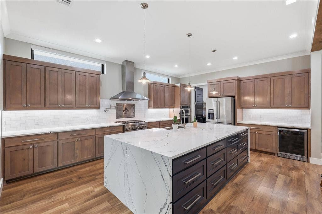 211 Shahan Drive, Shady Shores, TX 76208 View of kitchen island, cabinetry, wine fridge