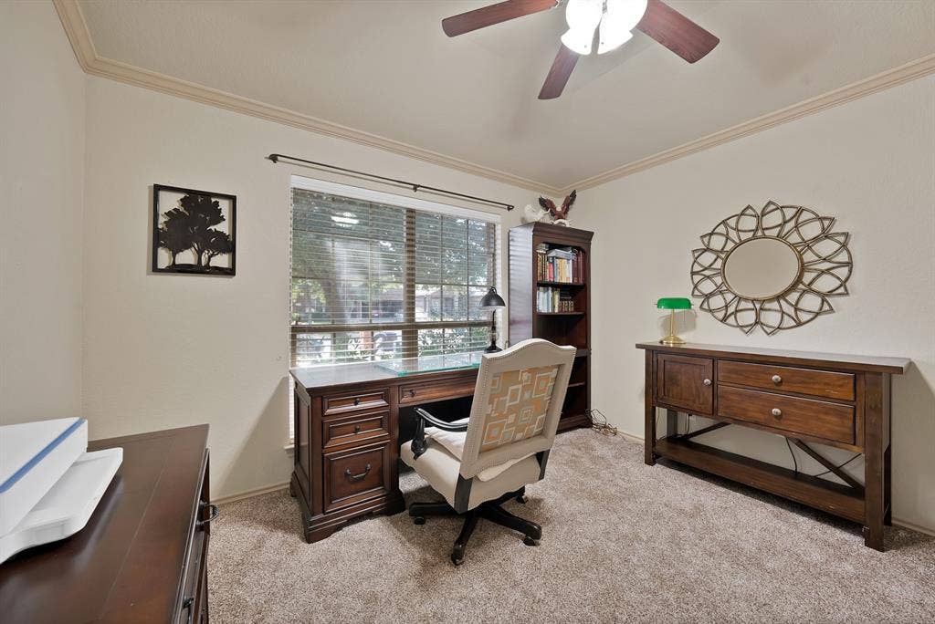 Wall-to-wall carpeting, crown molding, and a ceiling fan with integrated lighting