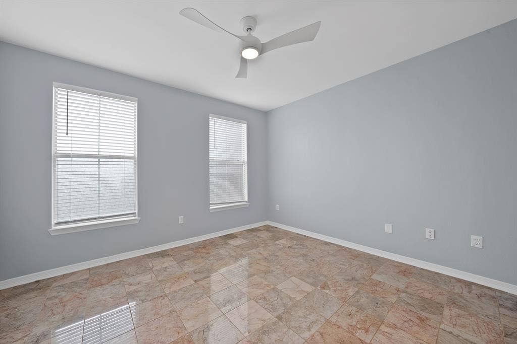 330 Las Colinas Boulevard E, #338, Irving, TX 75039 Marble-style tile flooring, two windows with blinds, and a contemporary ceiling fan with integrated lighting