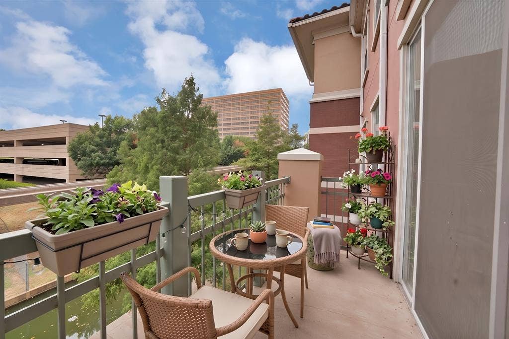 330 Las Colinas Boulevard E, #338, Irving, TX 75039 Balcony featuring a sliding glass door, metal railing, and stucco exterior walls