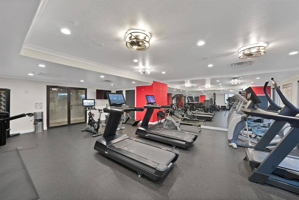 330 Las Colinas Boulevard E, #338, Irving, TX 75039 Fitness center with black rubber flooring, recessed lighting, and mirrored wall