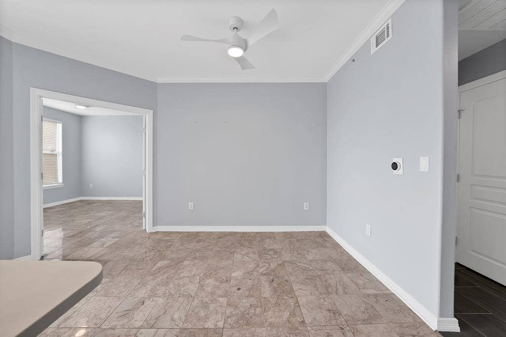 330 Las Colinas Boulevard E, #338, Irving, TX 75039 Recessed lighting, crown molding, ceiling fan, tile flooring, and white trim throughout