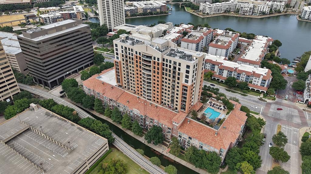 330 Las Colinas Boulevard E, #338, Irving, TX 75039 Multi-story residential building with a terraced design, a rooftop swimming pool, and immediate water access