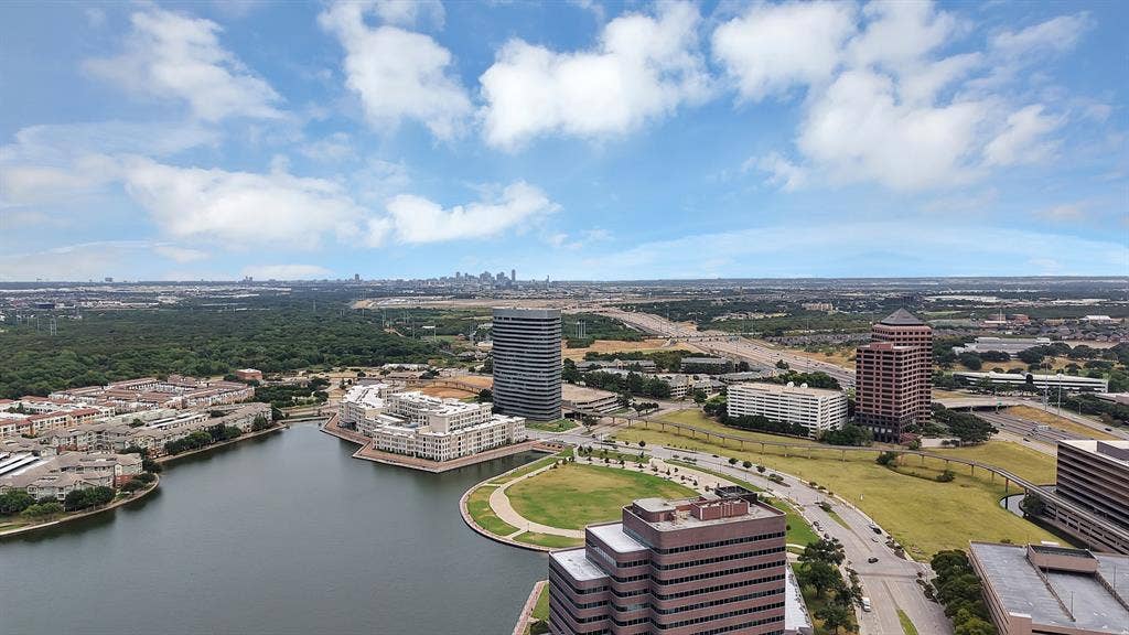 330 Las Colinas Boulevard E, #338, Irving, TX 75039 Expansive urban landscape featuring a large body of water, green park spaces, and multiple high-rise buildings