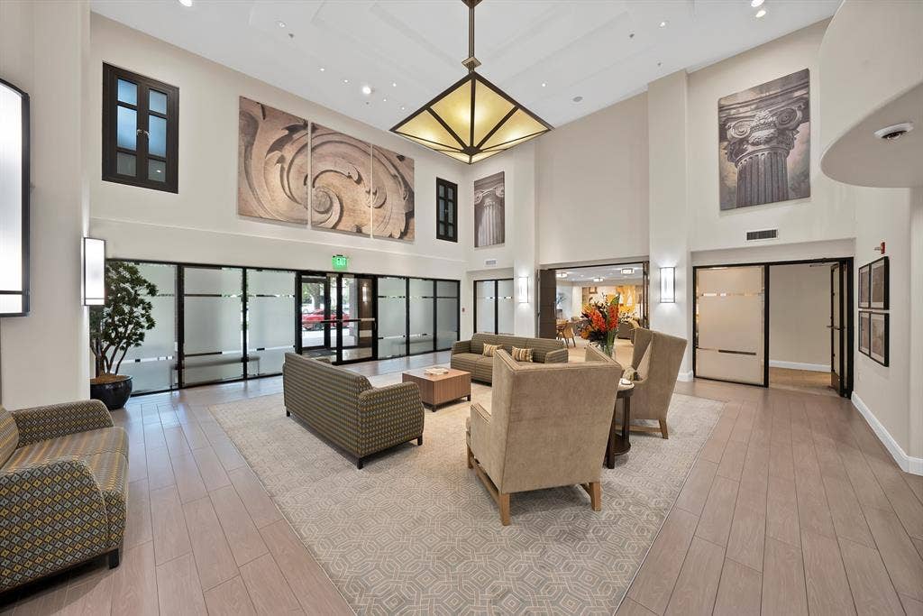 330 Las Colinas Boulevard E, #338, Irving, TX 75039 High ceilings with recessed lighting, wood-finish flooring, and a central chandelier