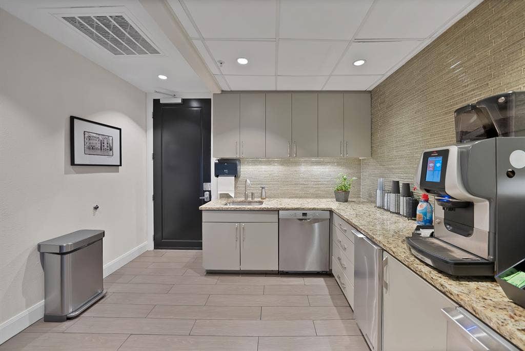330 Las Colinas Boulevard E, #338, Irving, TX 75039 L-shaped counter with stone-finish countertops, subway tile backsplash, and stainless steel appliances