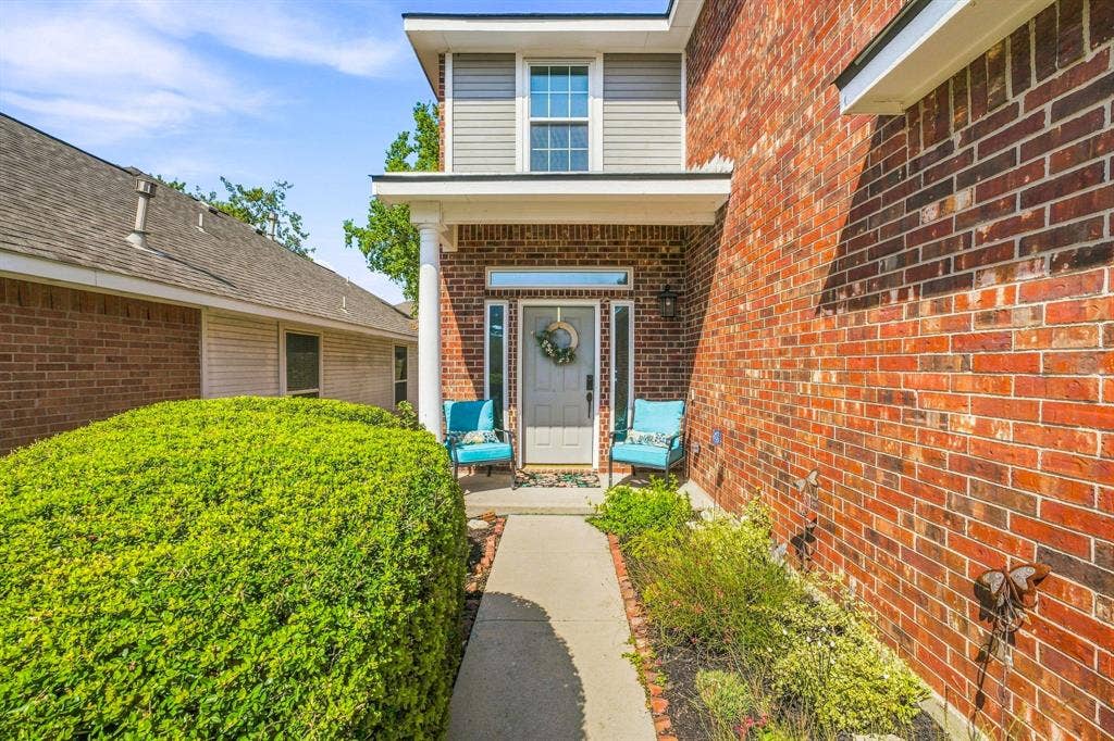 6913 Chaco Trail, Fort Worth, TX 76137 Brick exterior with a second-story siding accent