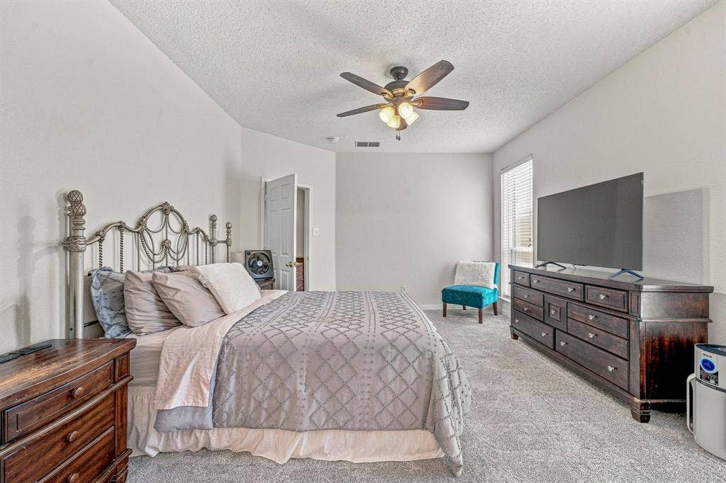6913 Chaco Trail, Fort Worth, TX 76137 Carpeted room with vaulted ceiling and ceiling fan with integrated lighting