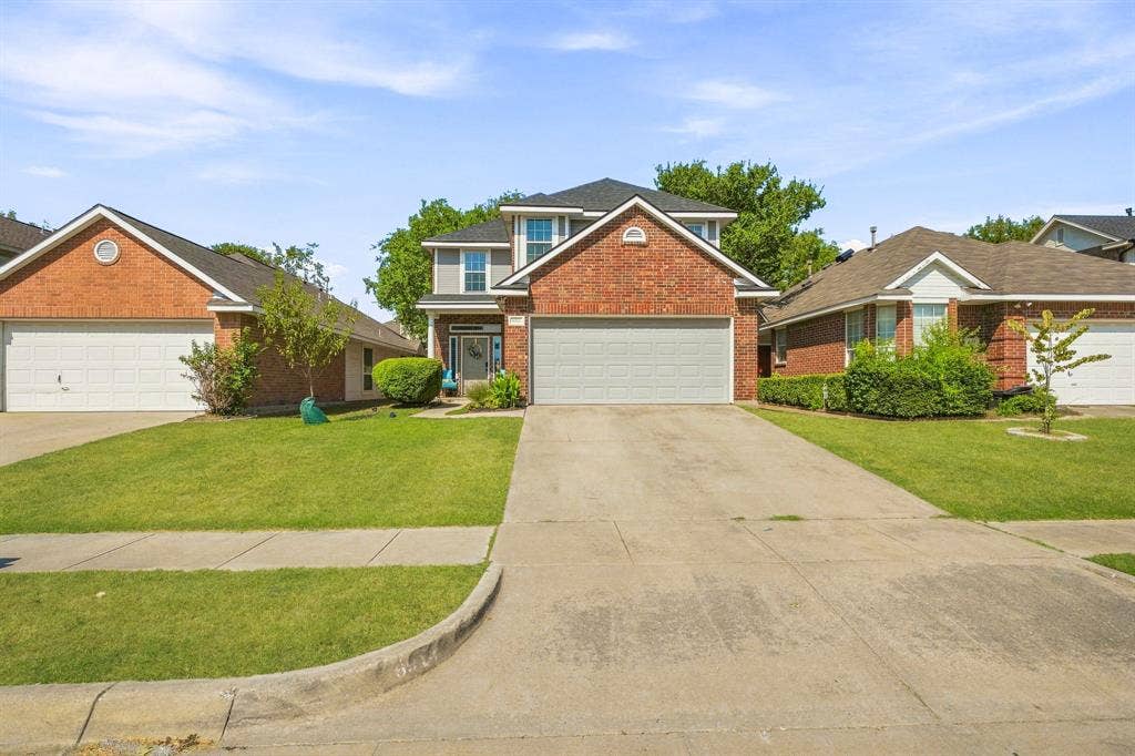 6913 Chaco Trail, Fort Worth, TX 76137 Brick and siding exterior with a two-car garage, concrete driveway, and established landscaping
