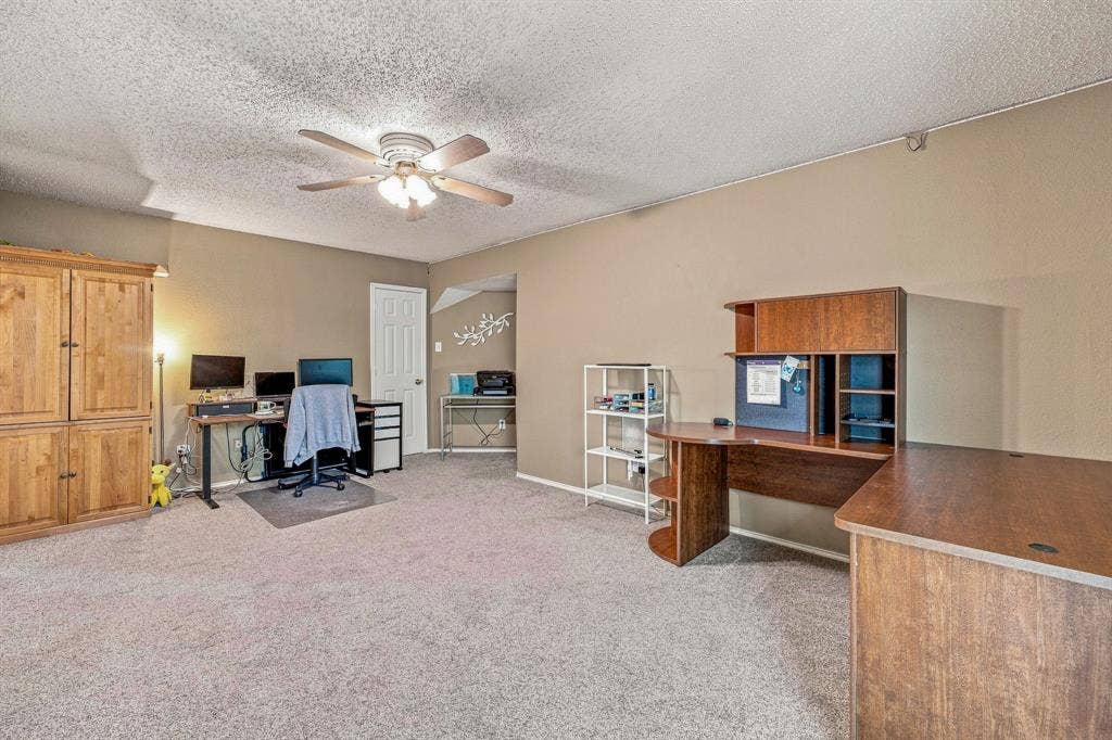 6913 Chaco Trail, Fort Worth, TX 76137 Carpeted room featuring neutral wall tones and a ceiling fan