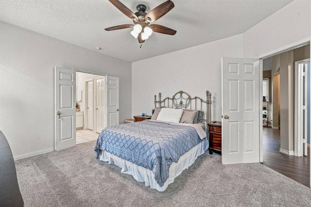 6913 Chaco Trail, Fort Worth, TX 76137 Carpeted flooring, vaulted ceiling, and a ceiling fan with integrated lighting