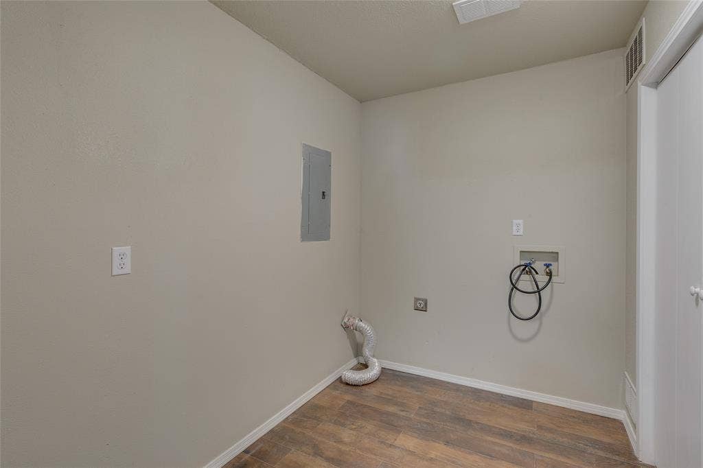 157 Harbor Drive, Gun Barrel City, TX 75156 Washroom featuring dark wood-type flooring, washer hookup, and electric panel