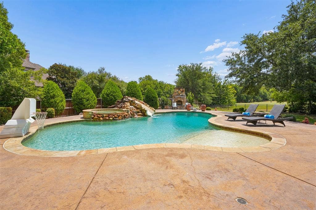 1712 Singletree Court, McKinney, TX 75072 Nine-foot-deep PebbleTec diving pool anchors the resort-style backyard.
