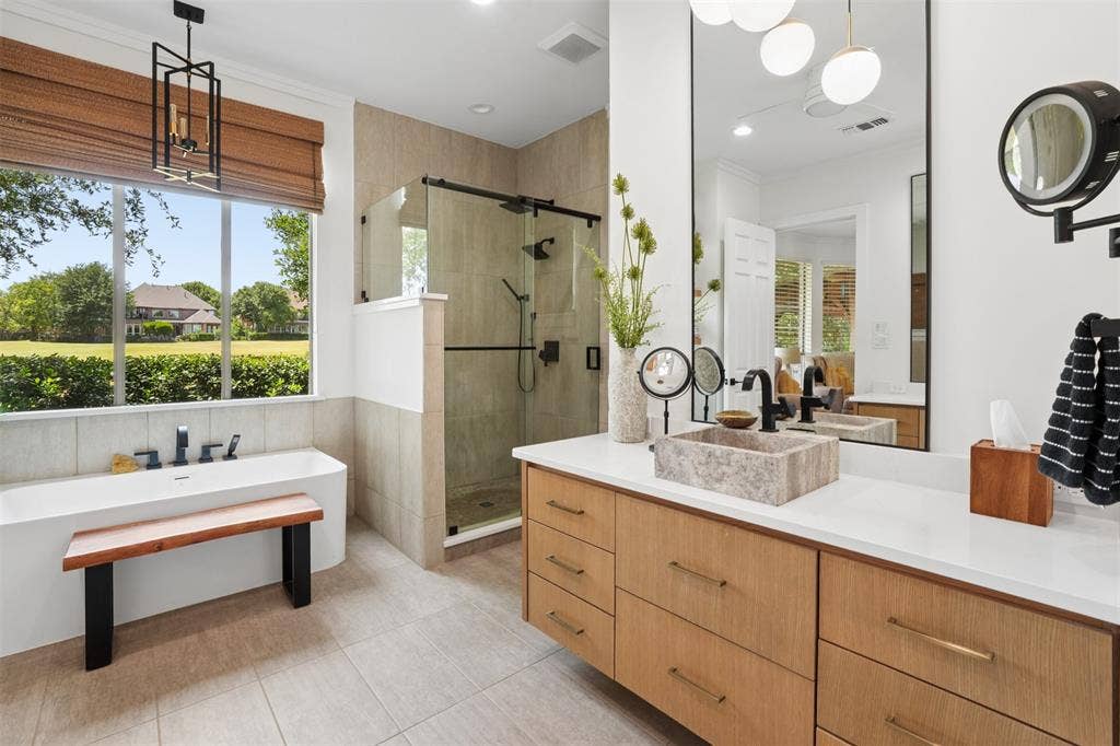 1712 Singletree Court, McKinney, TX 75072 Remodeled primary bathroom offers a bright, sophisticated retreat with generous vanity space.