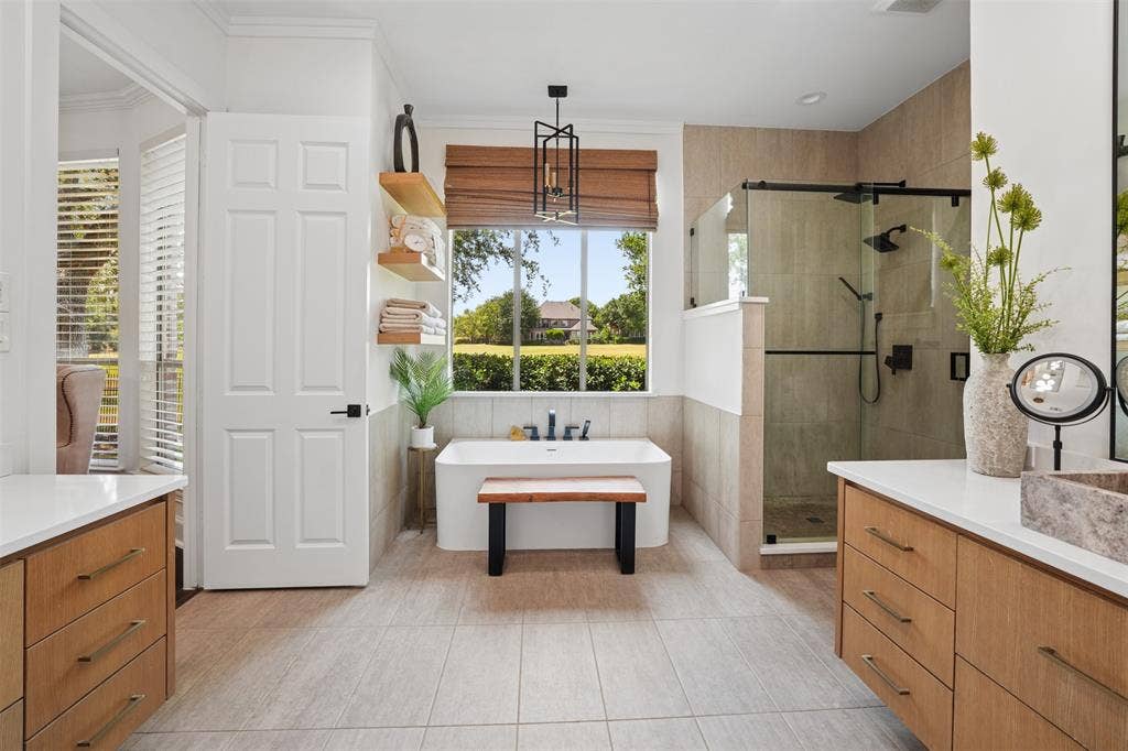 1712 Singletree Court, McKinney, TX 75072 Updated primary bath features dual vanities, extensive cabinetry and abundant natural light.