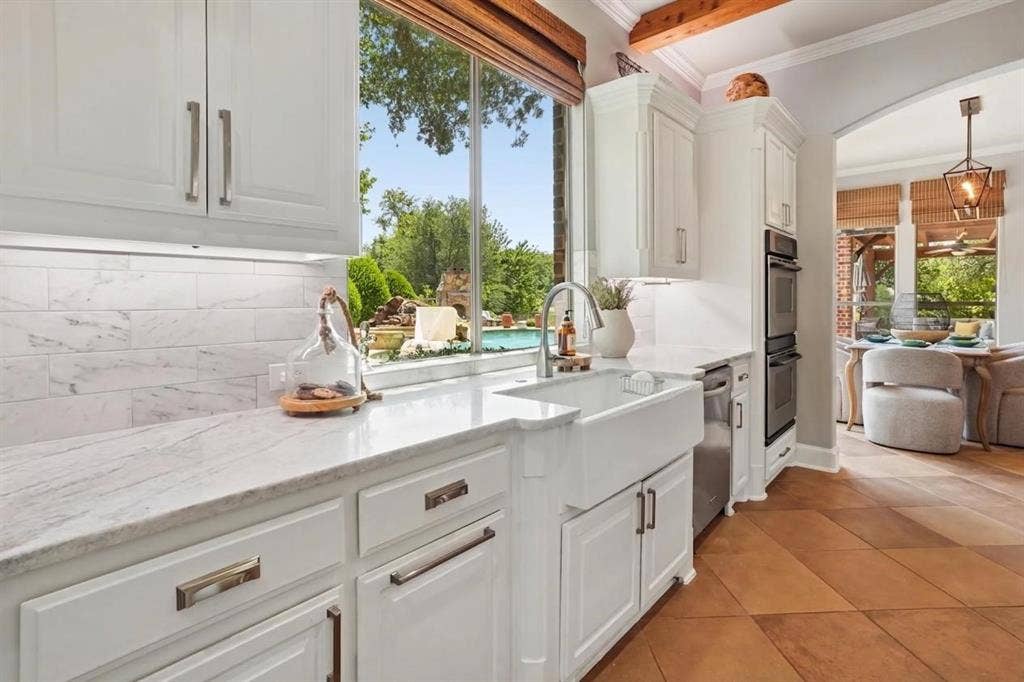 1712 Singletree Court, McKinney, TX 75072 Custom hardware, a porcelain farmhouse sink and a kitchen window view that makes you smile.