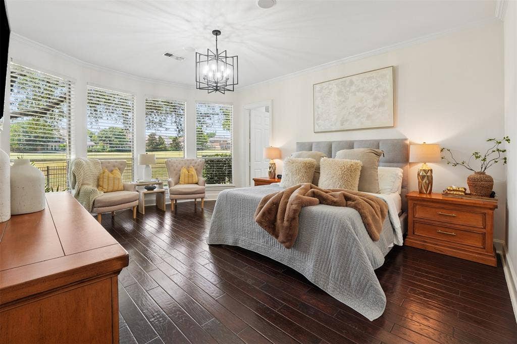 1712 Singletree Court, McKinney, TX 75072 Spacious downstairs primary suite offers hardwood floors and a peaceful view toward the backyard.