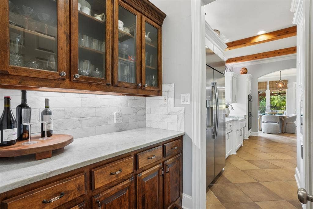 1712 Singletree Court, McKinney, TX 75072 Built-in cabinetry at the butler pantry adds functional storage and a polished transition between living and entertaining spaces.