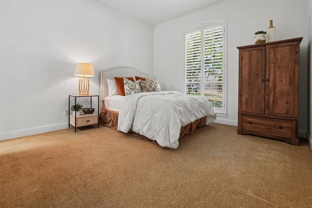 1712 Singletree Court, McKinney, TX 75072 Downstairs bedroom 2 provides private guest accommodations with en-suite bath access.