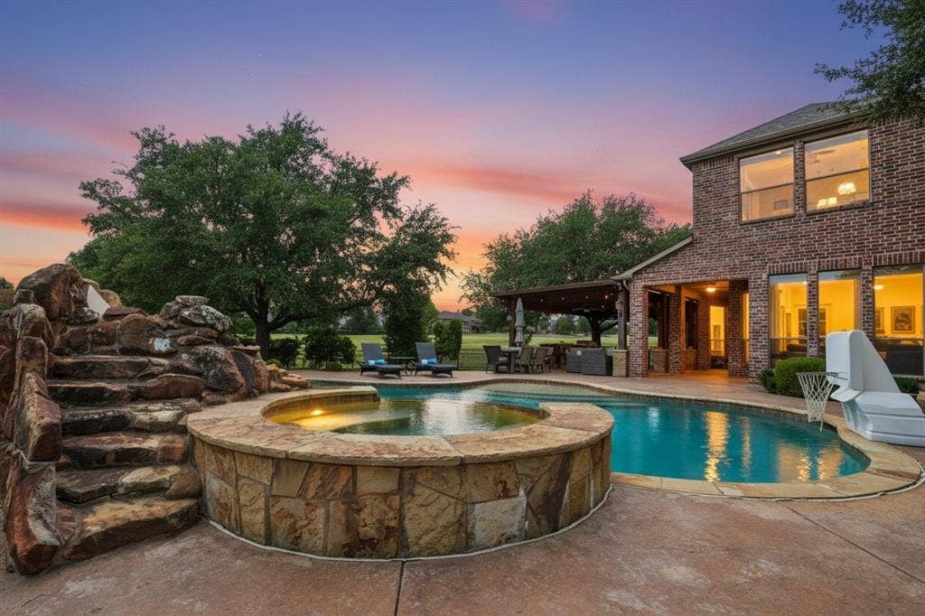 1712 Singletree Court, McKinney, TX 75072 Nine-foot-deep PebbleTec diving pool anchors the resort-style backyard.