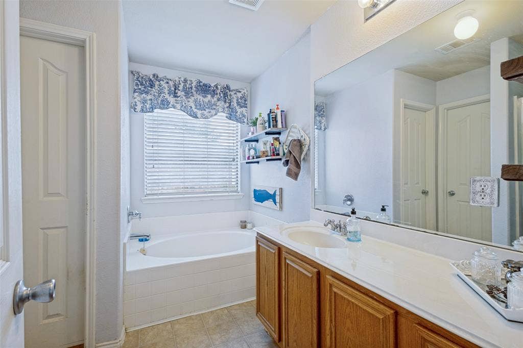 2118 Hanakoa Falls Drive, Anna, TX 75409 Full-width vanity, separate garden tub with plenty of space for two in the closet.