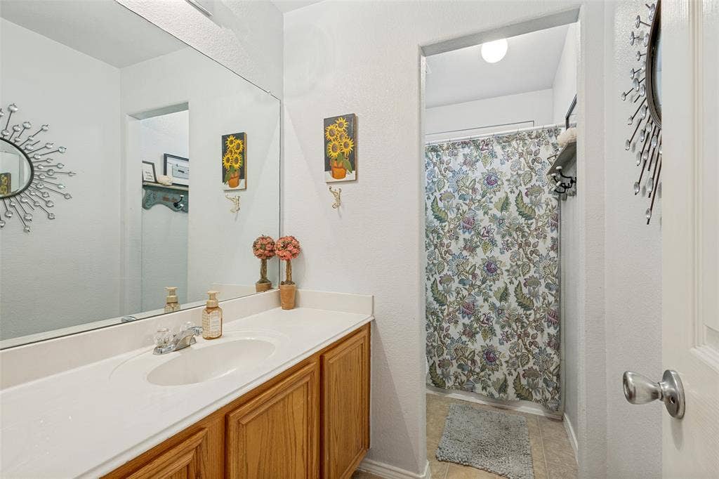 2118 Hanakoa Falls Drive, Anna, TX 75409 White vanity with a built-in sink, chrome faucet, and wood-finish cabinetry