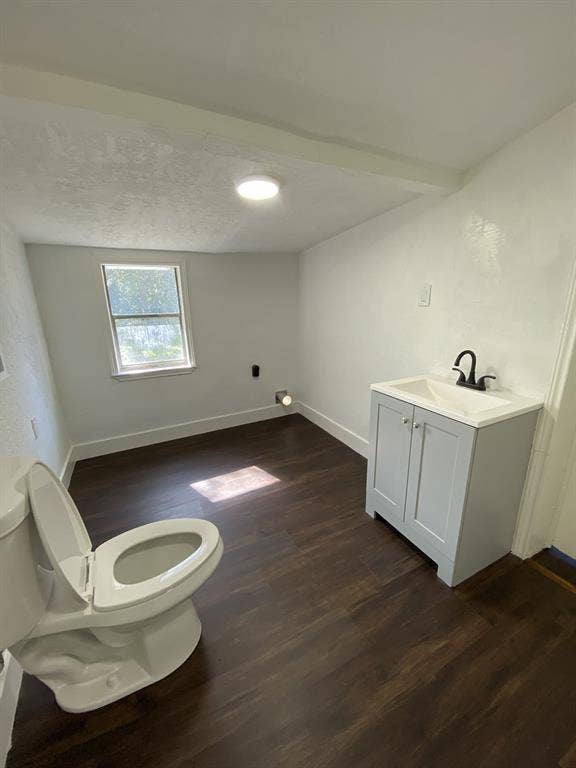 801 Walnut Street, Trinidad, TX 75163 Dark wood-finish flooring with a light gray vanity, white countertop, and modern black faucet