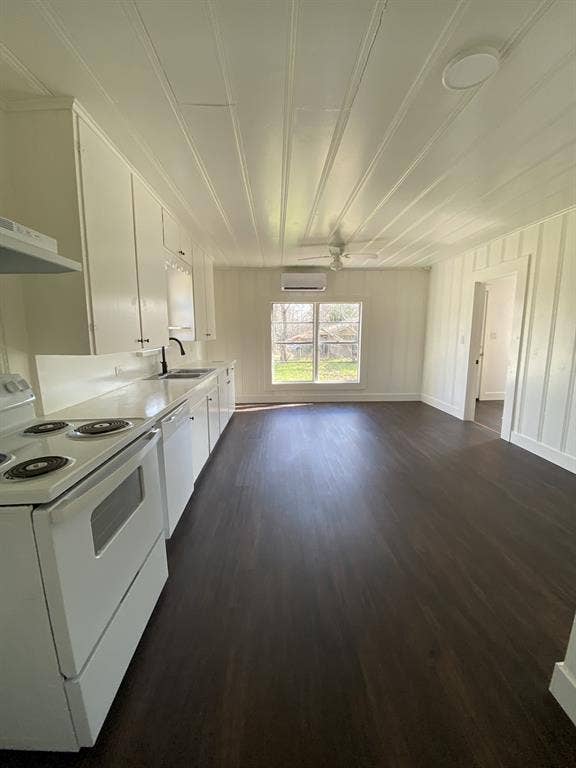 801 Walnut Street, Trinidad, TX 75163 Open-concept living space with dark wood-finish flooring, white paneling, and a ceiling fan