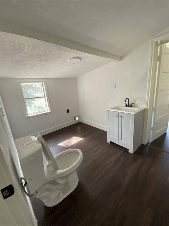 801 Walnut Street, Trinidad, TX 75163 Wood-finish flooring, built-in vanity cabinet with integrated sink and matte black faucet, and a window for natural light